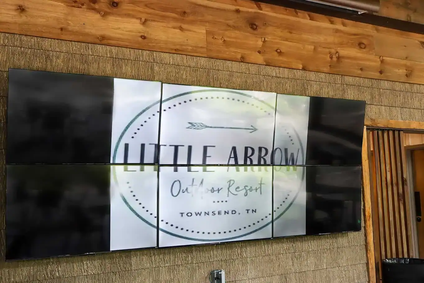 Large outdoor TV wall at Little Arrow Outdoor Resort in Townsend, TN.