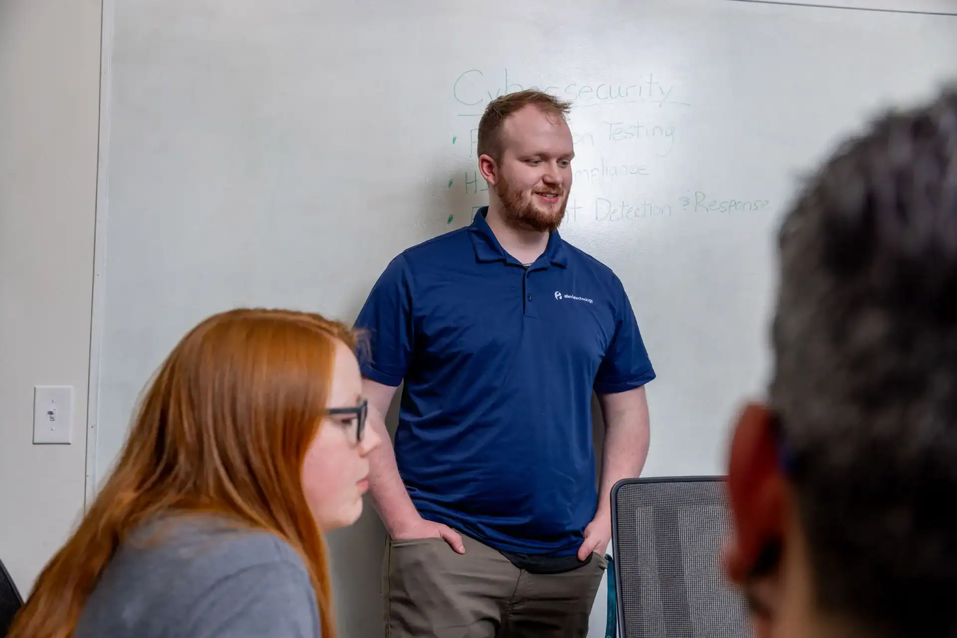 IT professional presenting cybersecurity concepts in a classroom setting.