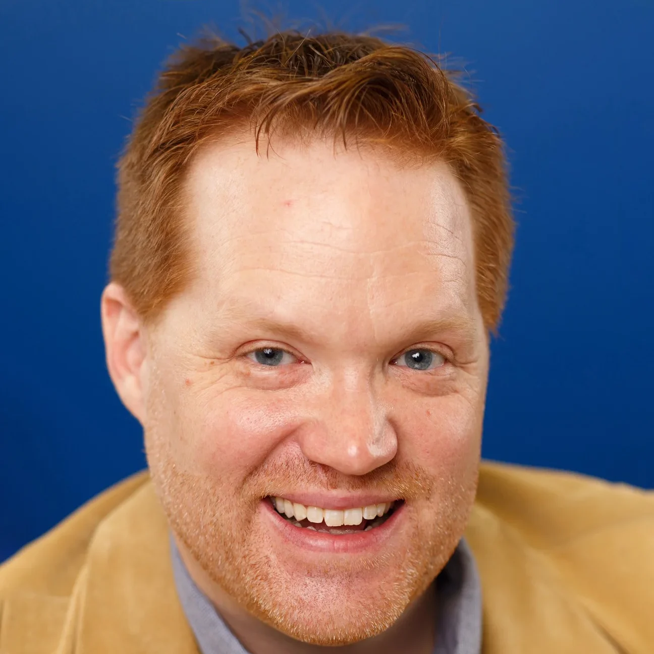 Happy man with red hair smiling, providing internet support in Maryville.