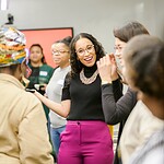 Altagracia Montilla in conversation with participants, hands in motion