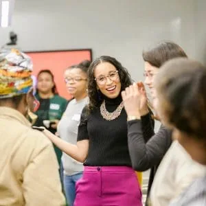 Altagracia Montilla in conversation with participants, hands in motion