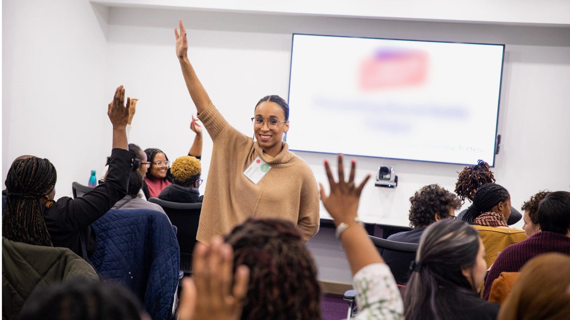 Participants raising their hands during a Conflict Bravery session