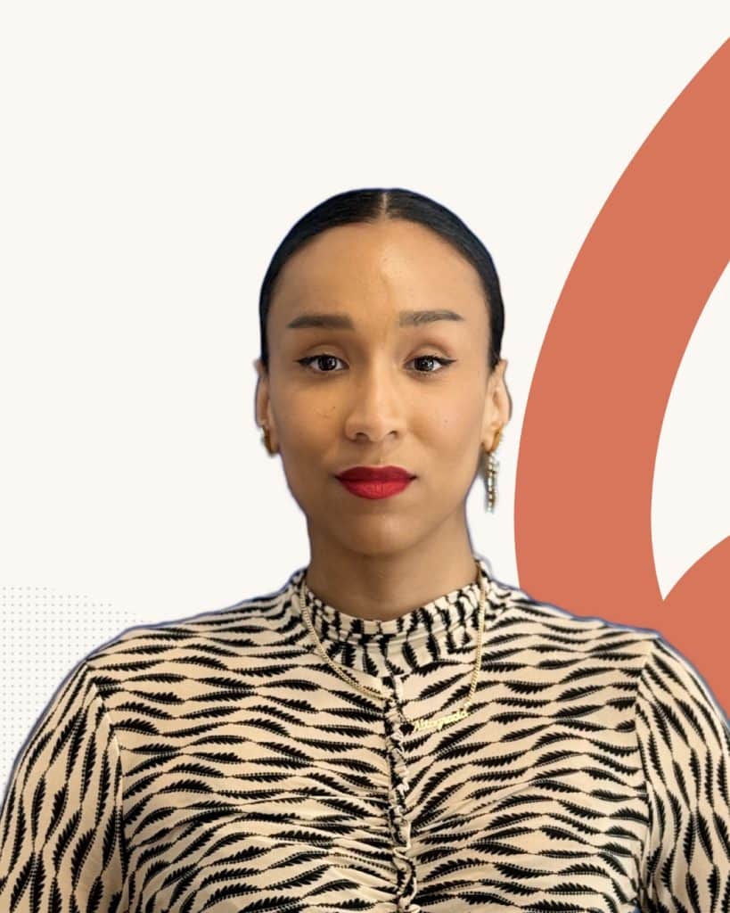 Professional woman in patterned blouse with organizational culture background.