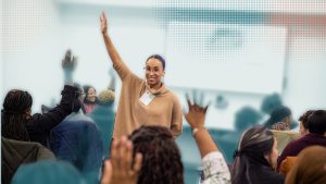 Confident woman leading a workshop on conflict bravery and organizational culture.
