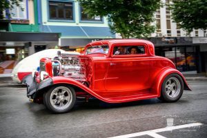 Classic red hot rod car at Americarna event, vintage vehicle showcase and street parade in New Zealand.
