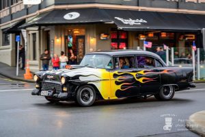 Vintage American car with flame decals at Americarna event in New Zealand.