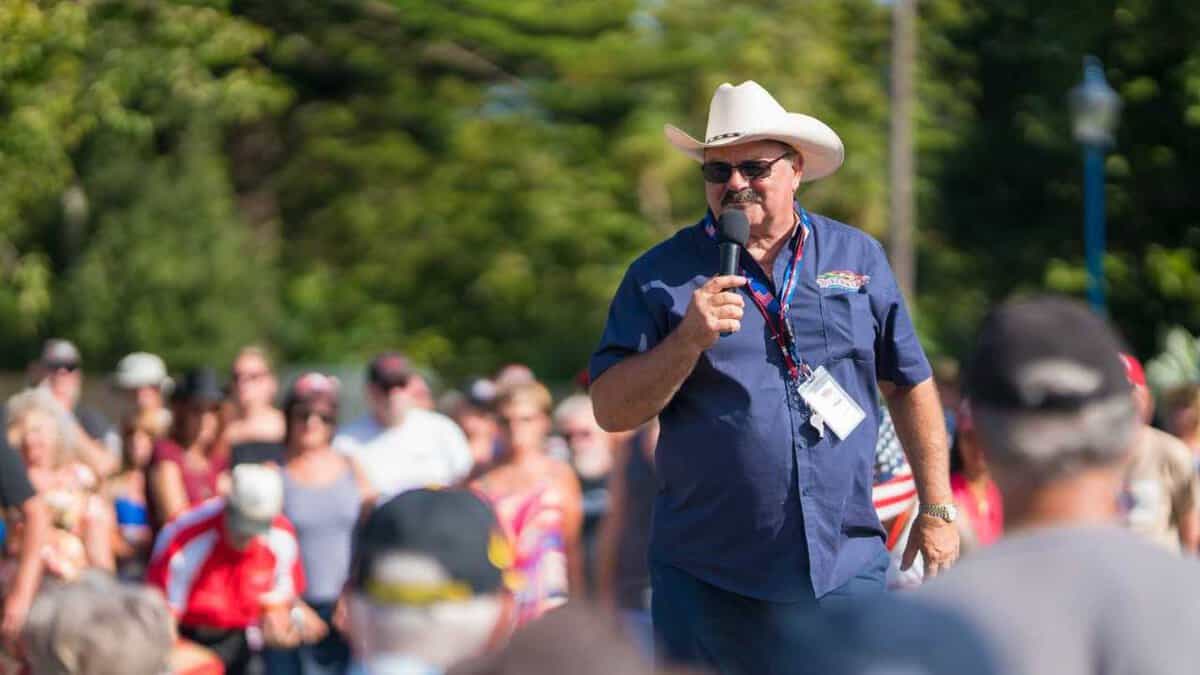 Classic car enthusiast speaking at Americarna event, New Zealand's premier automotive festival.
