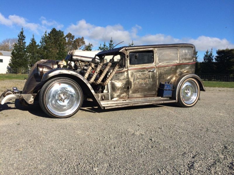 Rustic vintage hot rod with exposed engine and custom details, perfect for classic car enthusiasts.