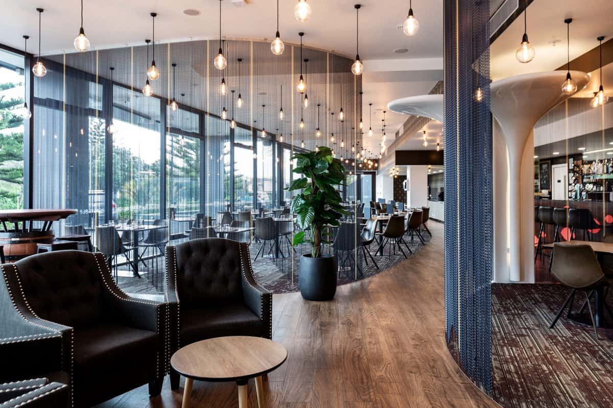 Modern American car-themed restaurant interior with contemporary furniture and ambient lighting in New Zealand.