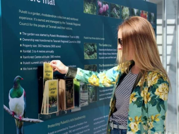 Bird at Puketi rainforest informational display in New Zealand.