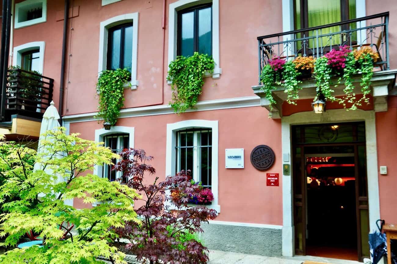 a building with plants on the windows