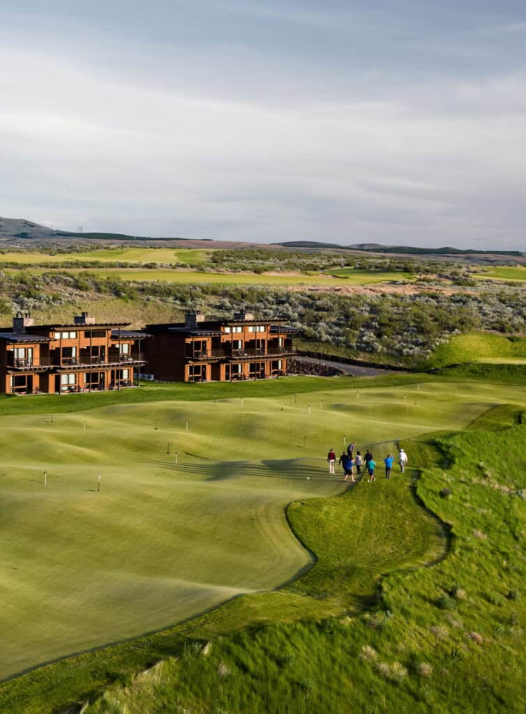 Golfers near luxurious lodge and greens