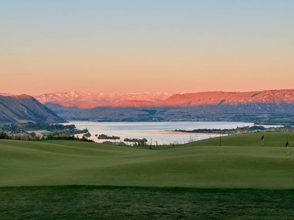 Sunset over rolling hills and lake