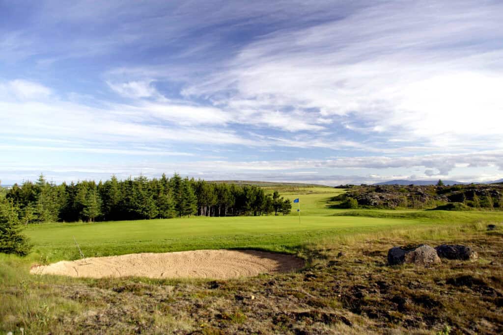Golf course with sand trap and trees