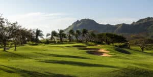 Lush green golf course with mountains