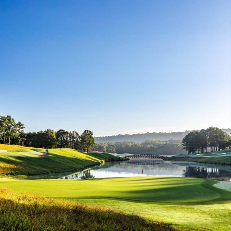 Serene golf course with reflective water