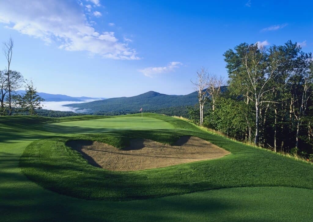 Lush golf course with scenic mountains