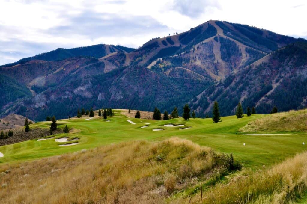Lush golf course with mountainous backdrop