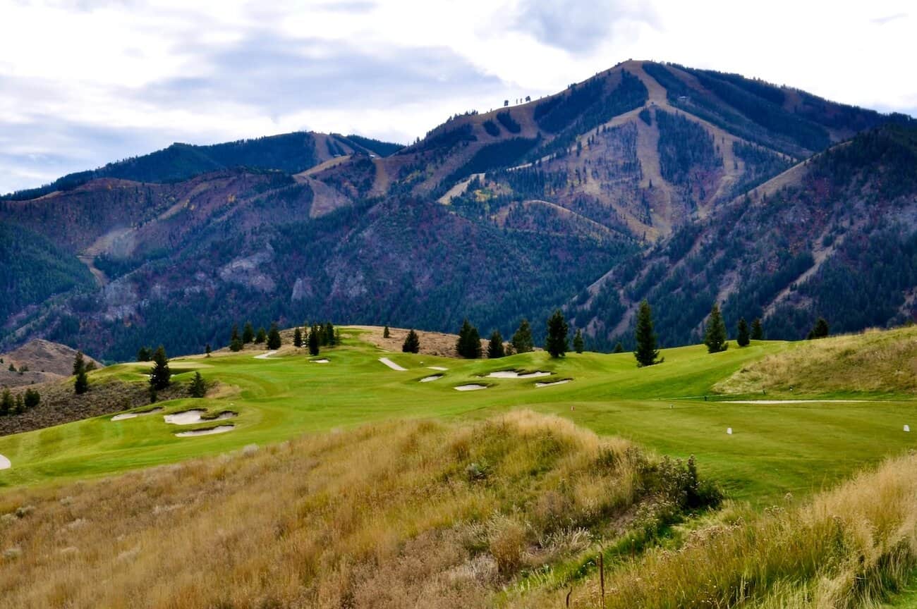 Lush golf course with mountainous backdrop