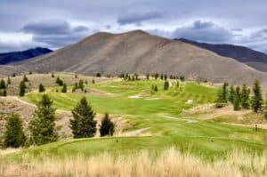 Lush golf course with mountainous backdrop