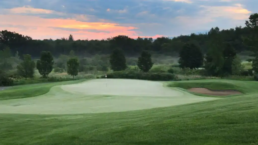 Serene golf course at sunrise.