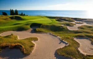 Coastal golf course with sandy bunkers.
