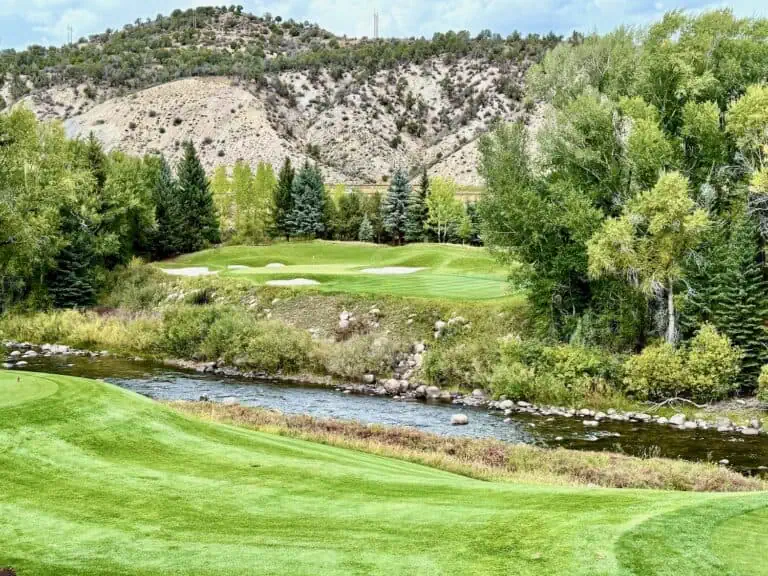 Lush green golf course by river