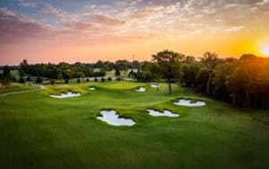 Sunset over a golf course landscape.