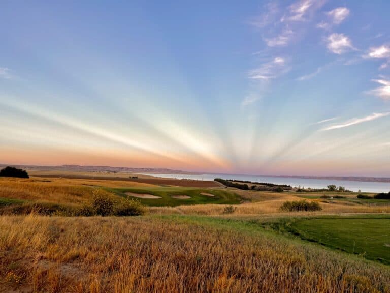 Sunset over golf course and lake