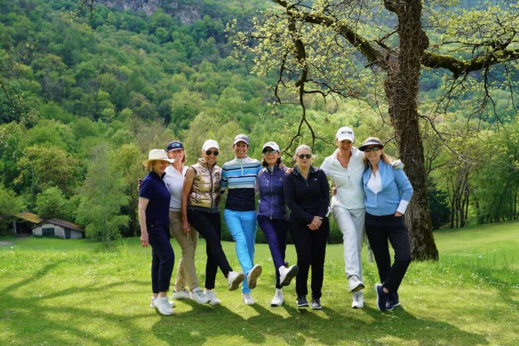 Group of women enjoying golf outdoors.