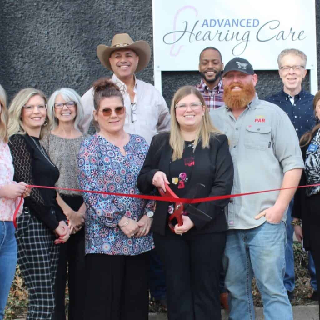 Andrea Wegner celebrates the ribbon cutting after purchasing Advanced Hearing Care, continuing the practice's legacy while introducing new technology and patient care.