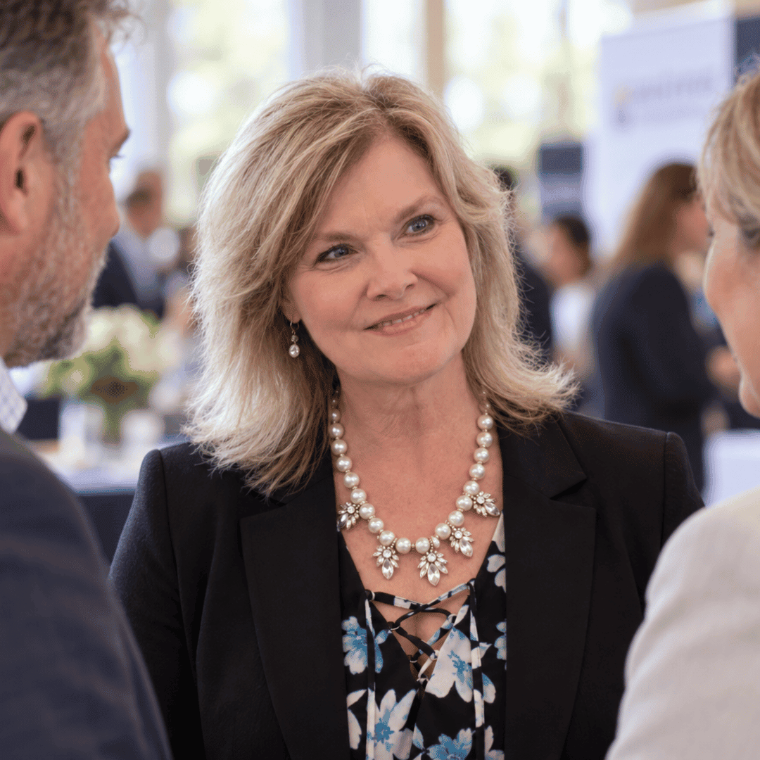 Angie Thompson talking with two people at a professional networking event