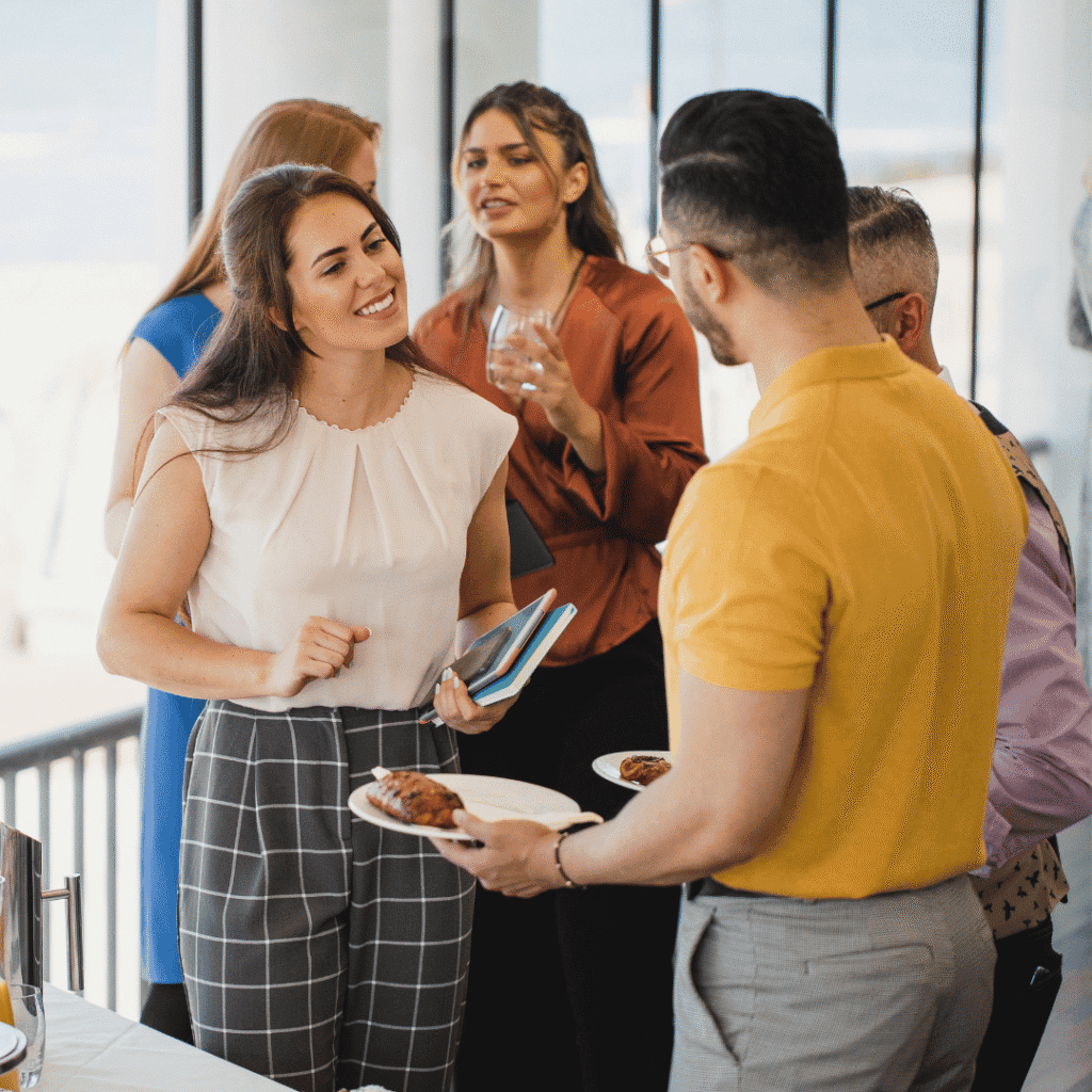 Professionals talking in small groups during a networking reception