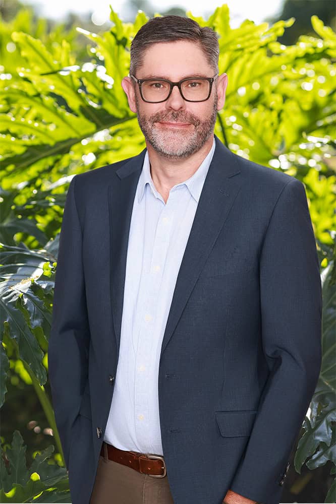 Professional man in a suit at Arbor Australis Consulting.