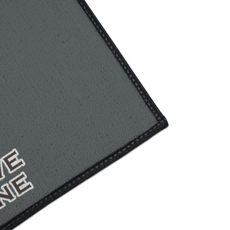 Gray doormat with black border and text design.