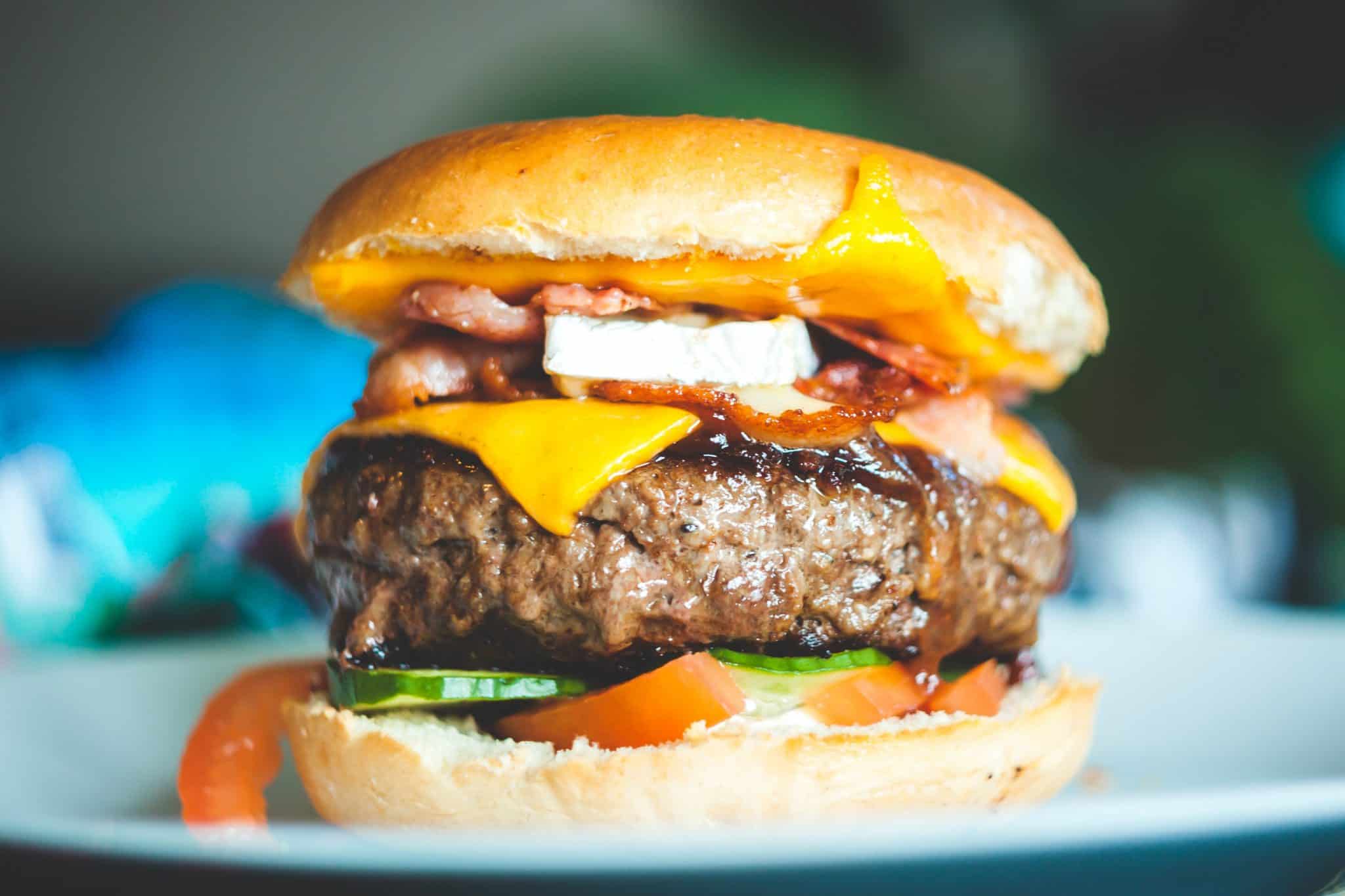 Burger with cheese and veggies on a bun
