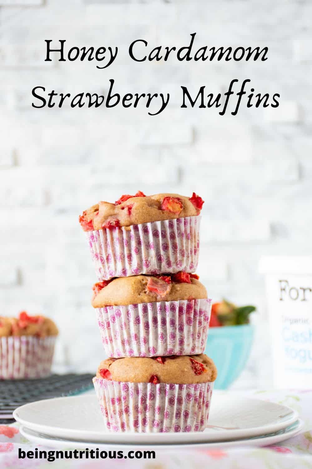 Stack of 3 strawberry muffins with the words Honey Cardamom Strawberry Muffins written above