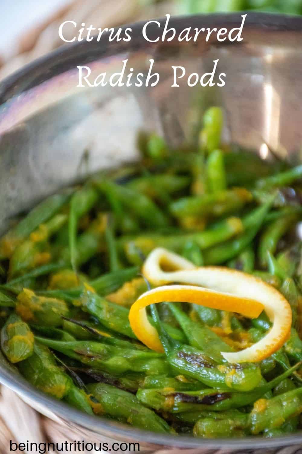 Silver bowl with charred radish pods, garnished with orange peel with text overlay: "Citrus Charred Radish Pods"