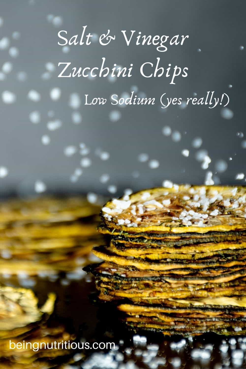 Image of 3 stacks of zucchini chips, with salt crystals falling all around.