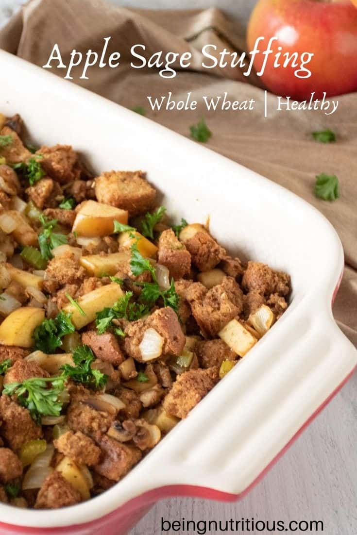 Stuffing in a large casserole dish. Whole apples visible in background. Text overlay: Apple sage stuffing, whole wheat, healthy.