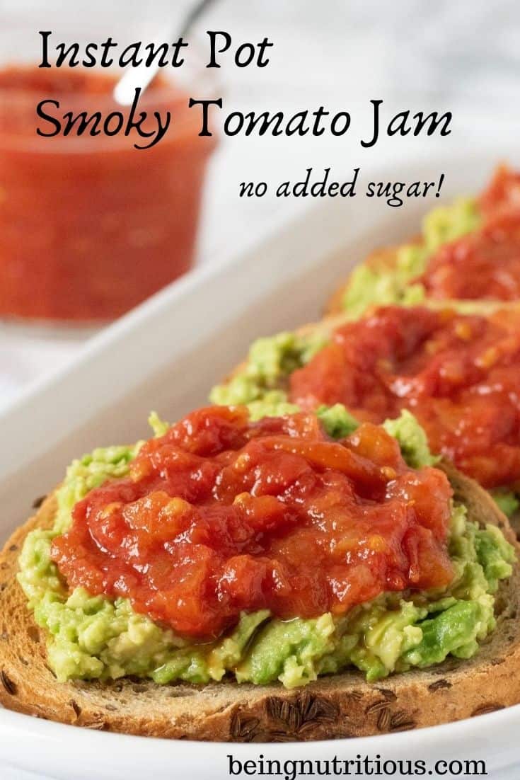 Close up of a round slice of rye bread smeared with avocado, and topped with tomato jam. Text overlay: Instant Pot Smoky Tomato Jam, no added sugar.