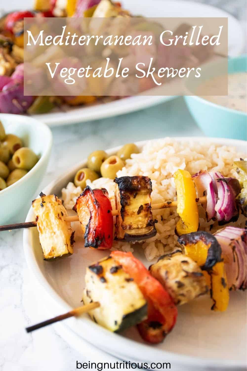 Plate with 2 veggie skewers and rice. Text overlay: Mediterranean Grilled Vegetable Skewers.
