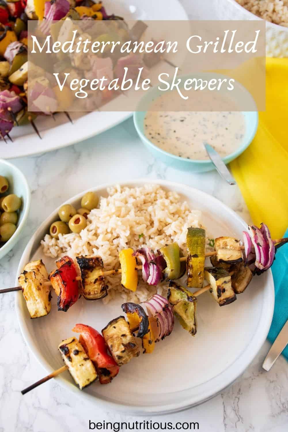 Plate with 2 veggie skewers and rice. Text overlay: Mediterranean Grilled Vegetable Skewers.