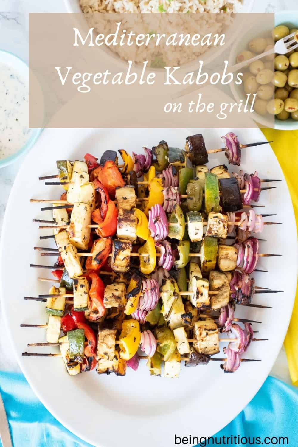 Serving platter with vegetable skewers piled on. Text overlay: Mediterranean Vegetable Kabobs on the Grill