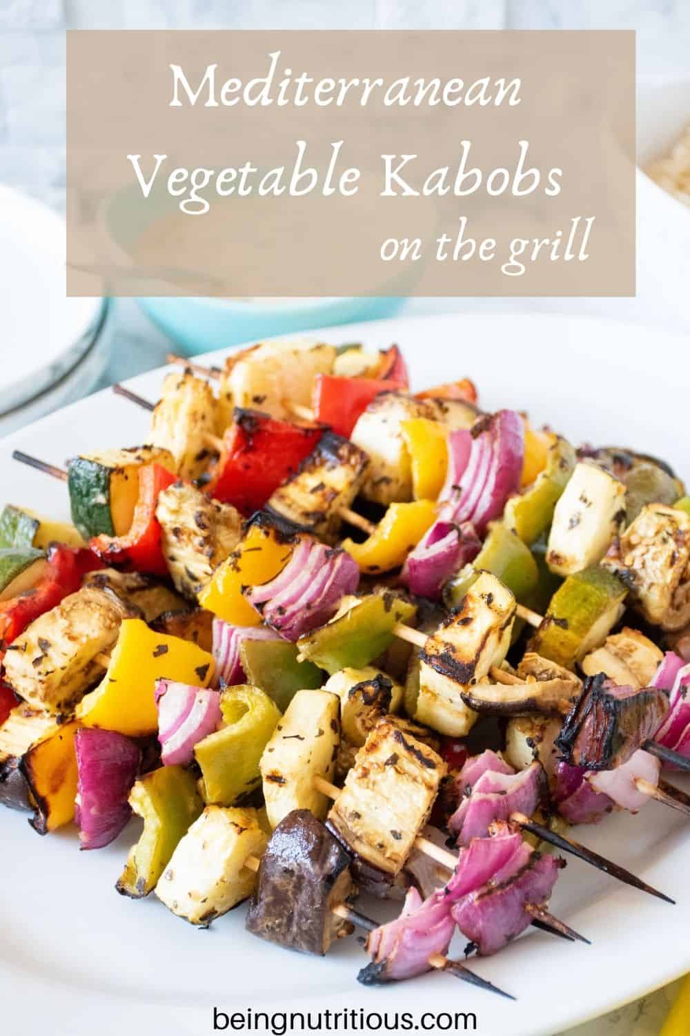 Serving platter with vegetable skewers piled on. Text overlay: Mediterranean Vegetable Kabobs on the Grill