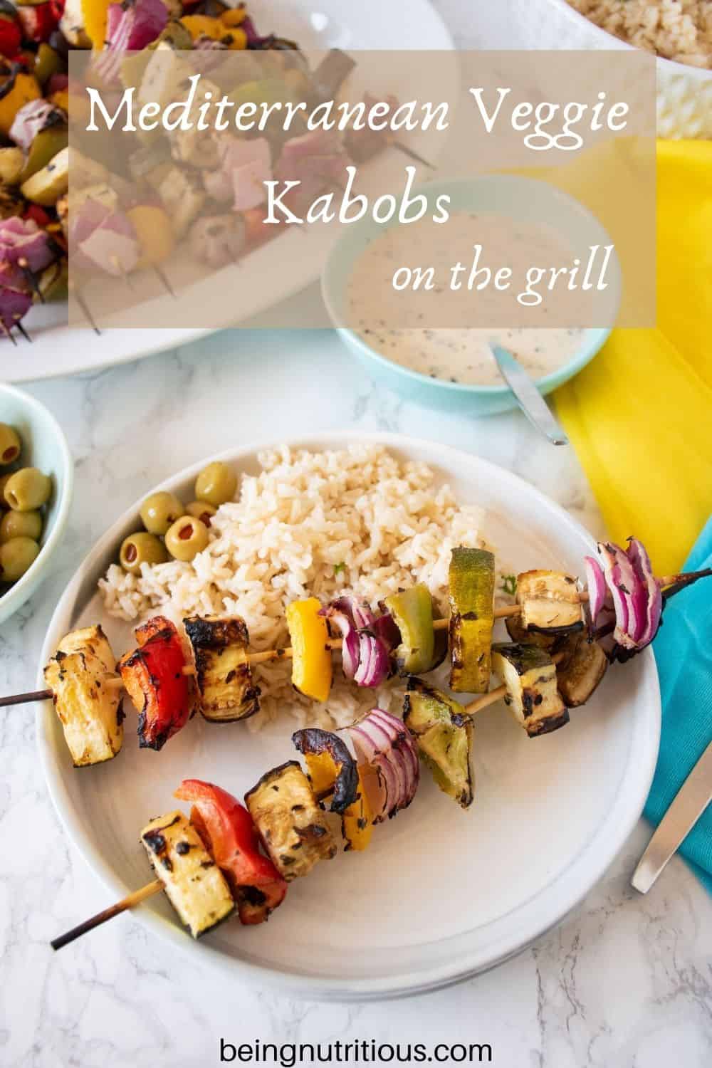 Plate with 2 veggie skewers and rice. Text overlay: Mediterranean Veggie Kabobs on the grill.