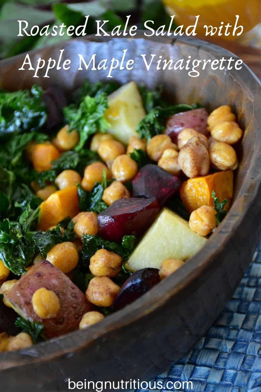 Kale salad in a wooden bowl. Text overlay: Roasted Kale Salad with Apple Maple Vinaigrette.
