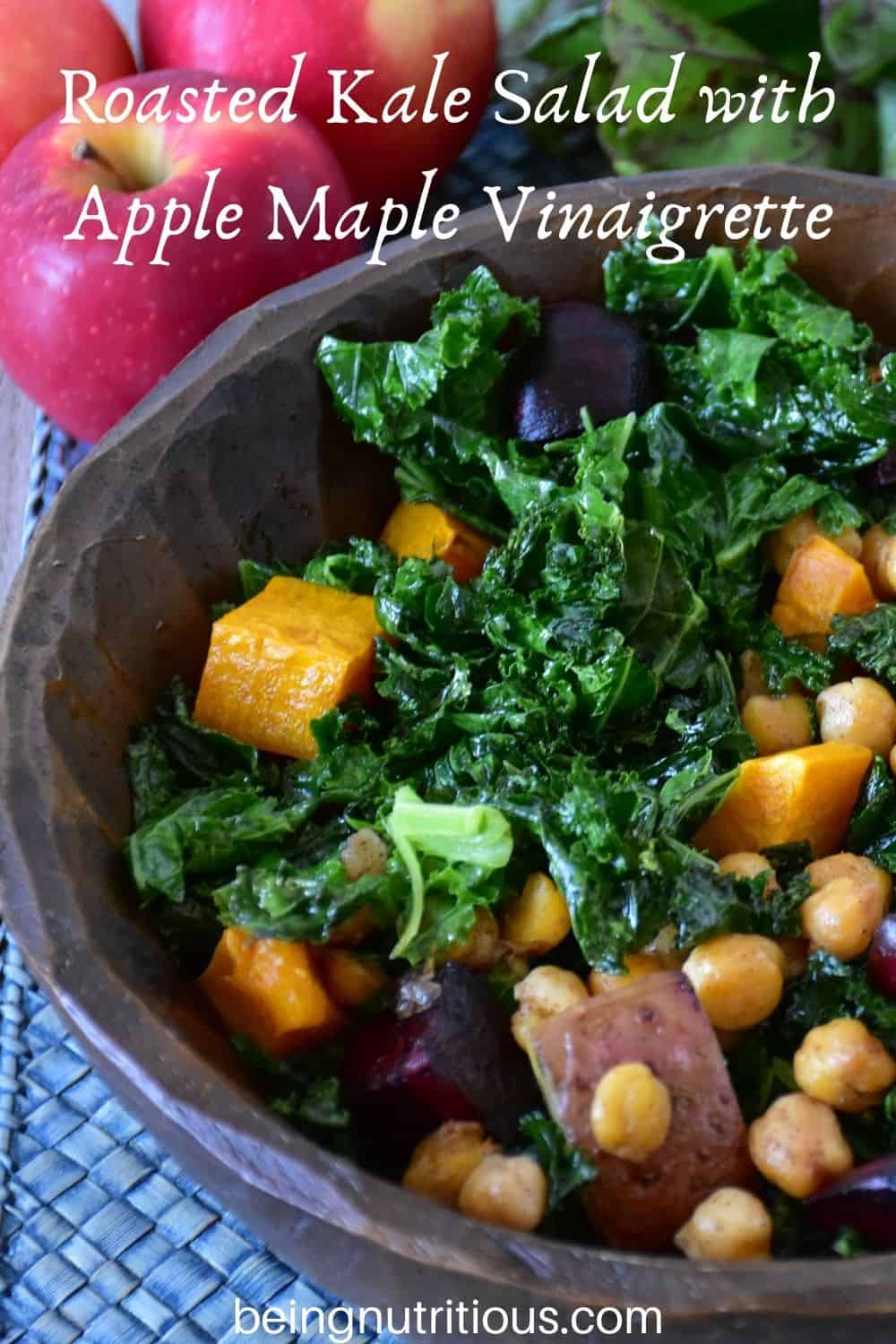 Kale salad in a wooden bowl. Text overlay: Roasted Kale Salad with Apple Maple Vinaigrette.