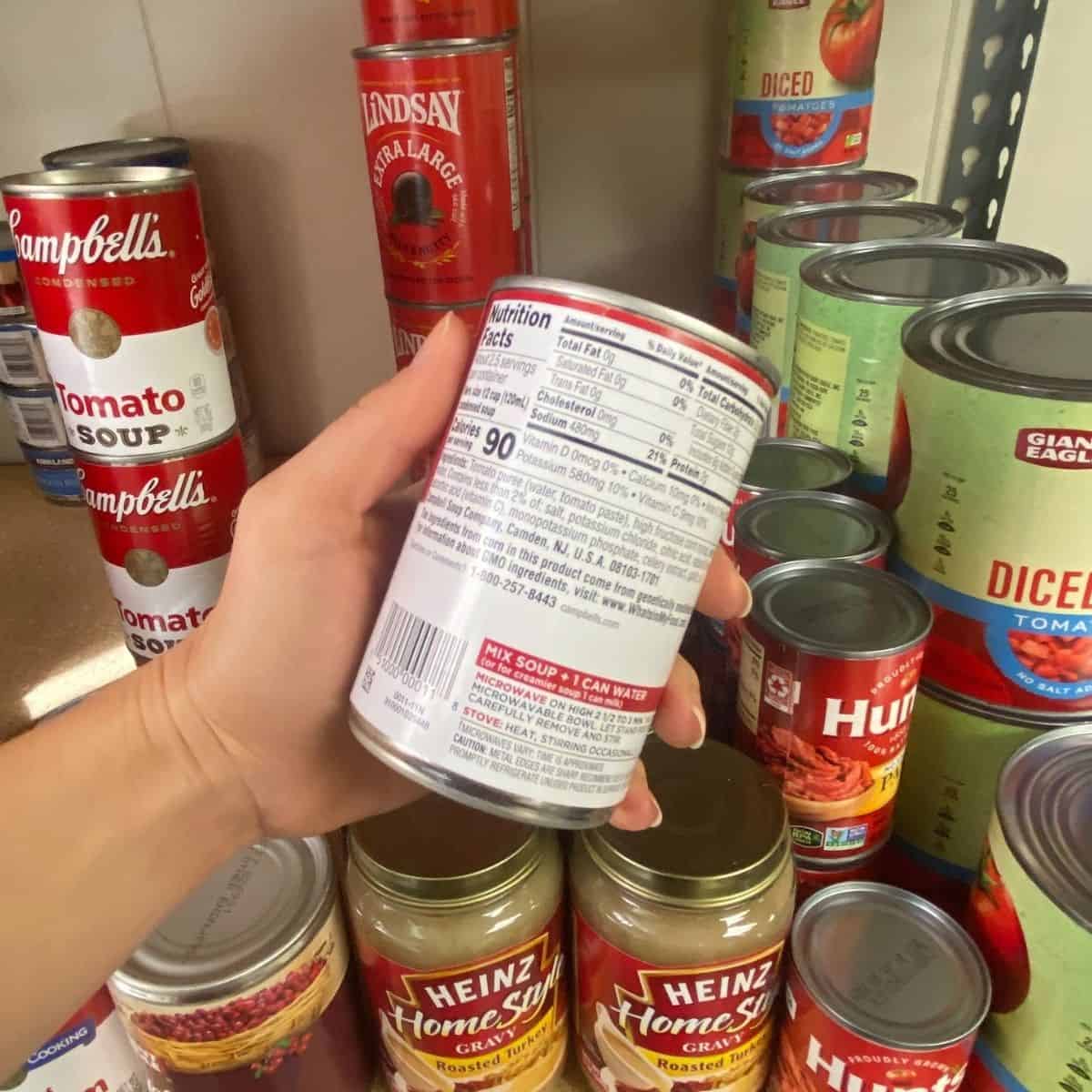Hand holding a can with the nutrition facts label showing