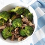 Roasted broccoli and mushrooms in a bowl.